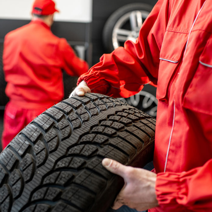 mechanic carrying tire
