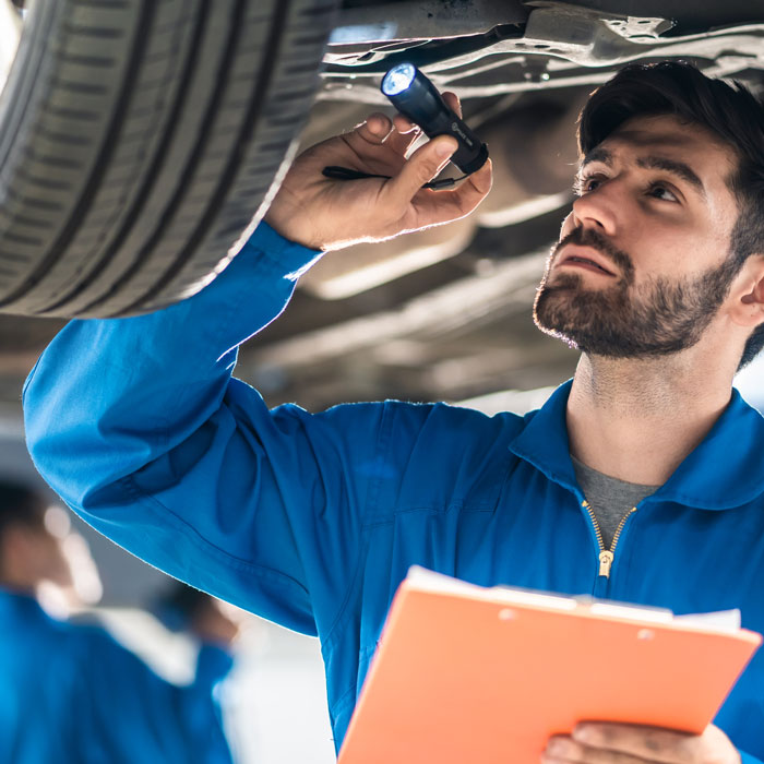 man inspecting tire on lift
