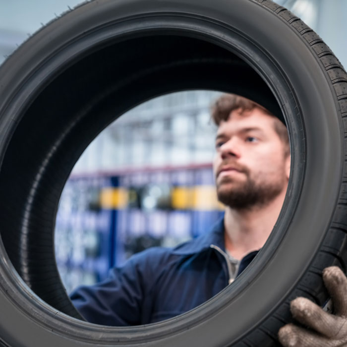 man inspecting tire
