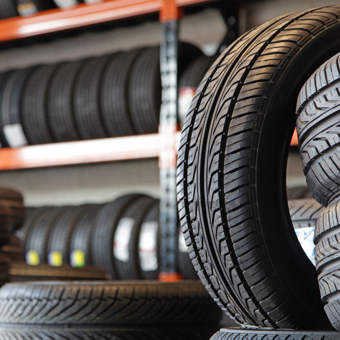 stack of tires with racks of more tires in the background
