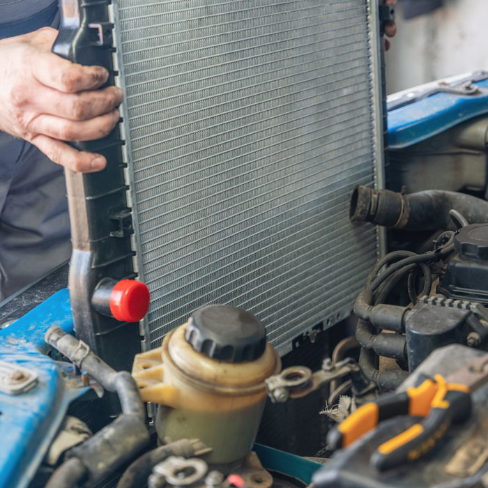 mechanic working on car radiator