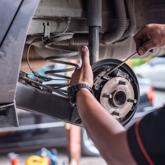 mechanic working on car brake pads