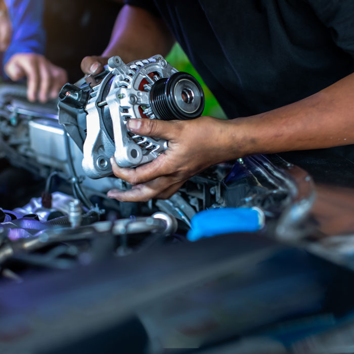 mechanic working on car holding part