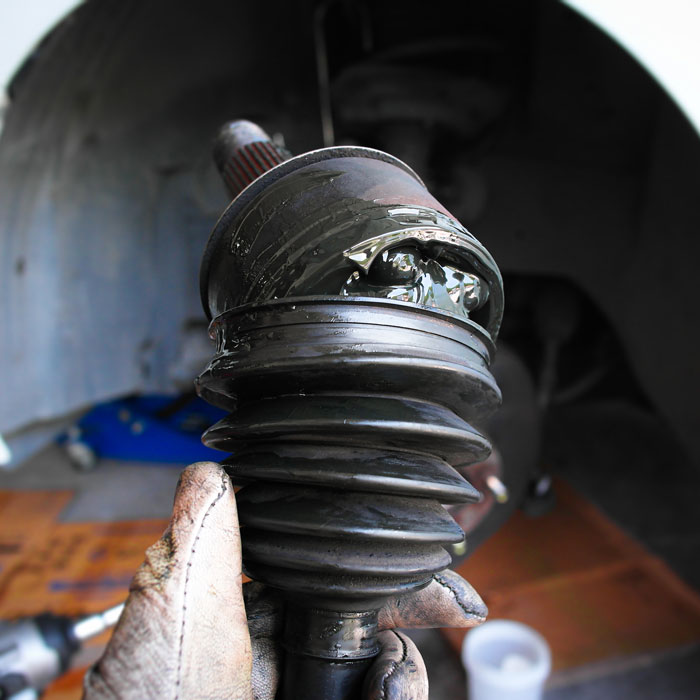 mechanic holding damaged car part