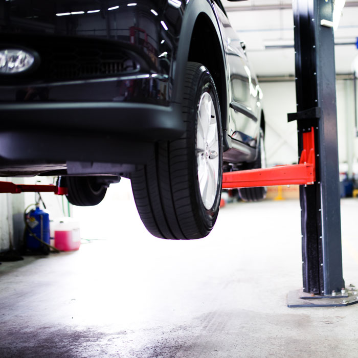 car on mechanic lift
