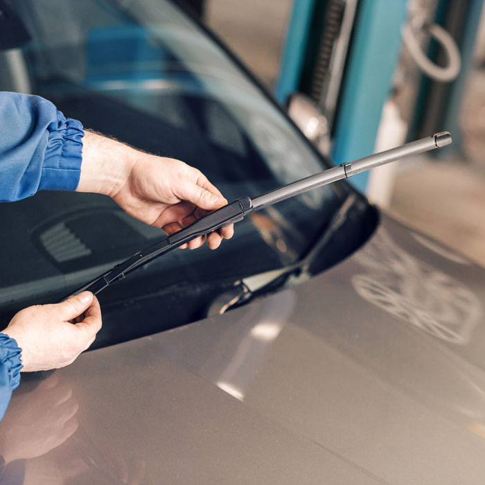 mechanic working on car wiper blades